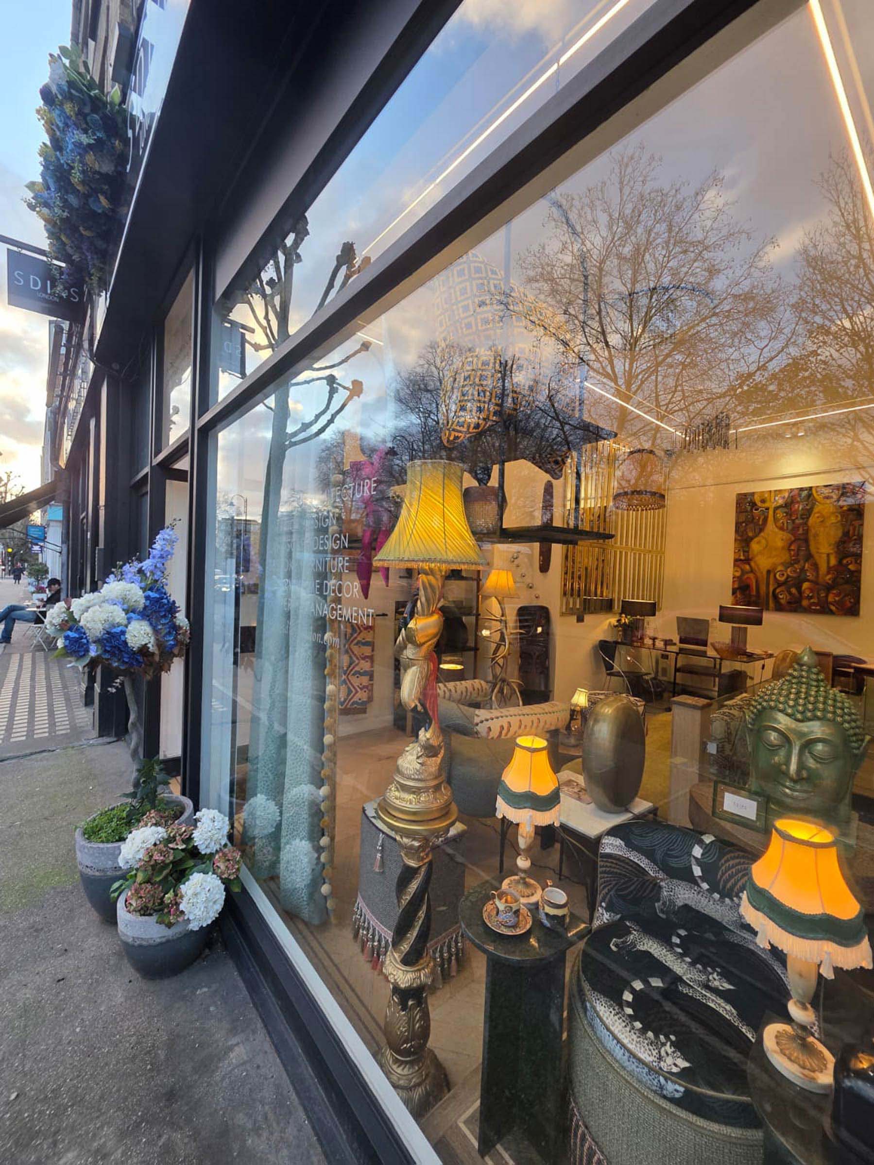Shop window displaying home decor items and lamps.